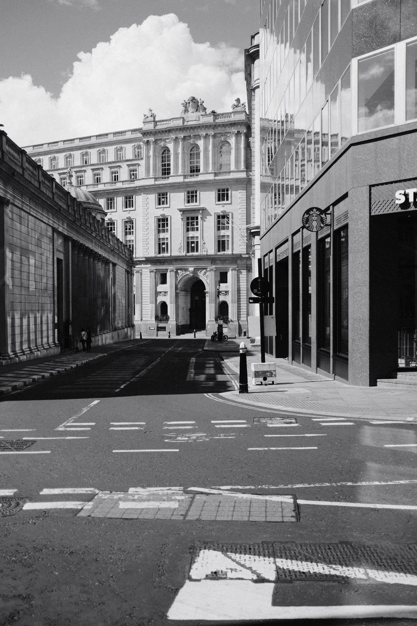 corner of Threadneedle Street in London, with Starbucks and Bank of England Museum in view, grayscale